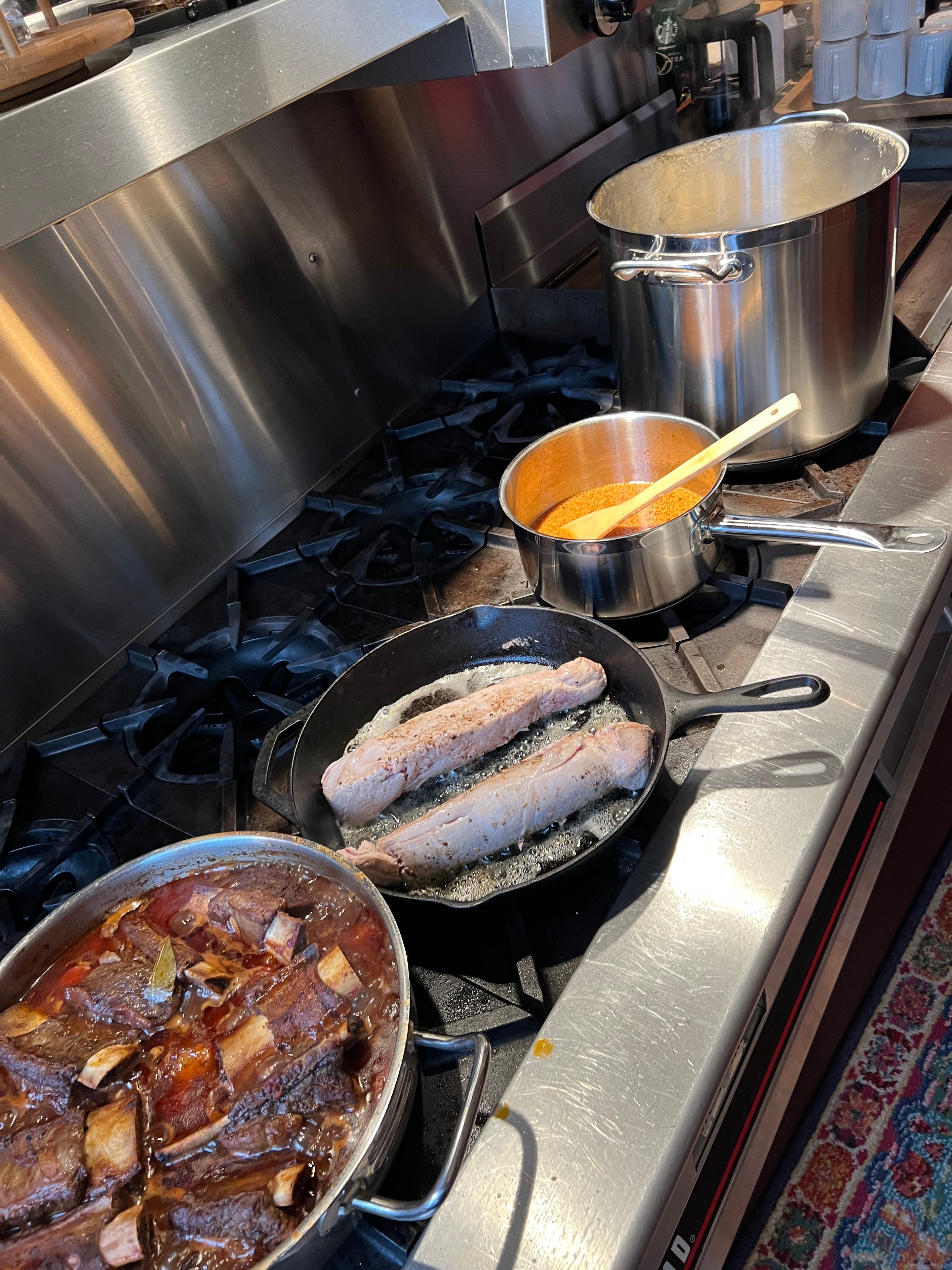 Professional kitchen cooking multiple dishes